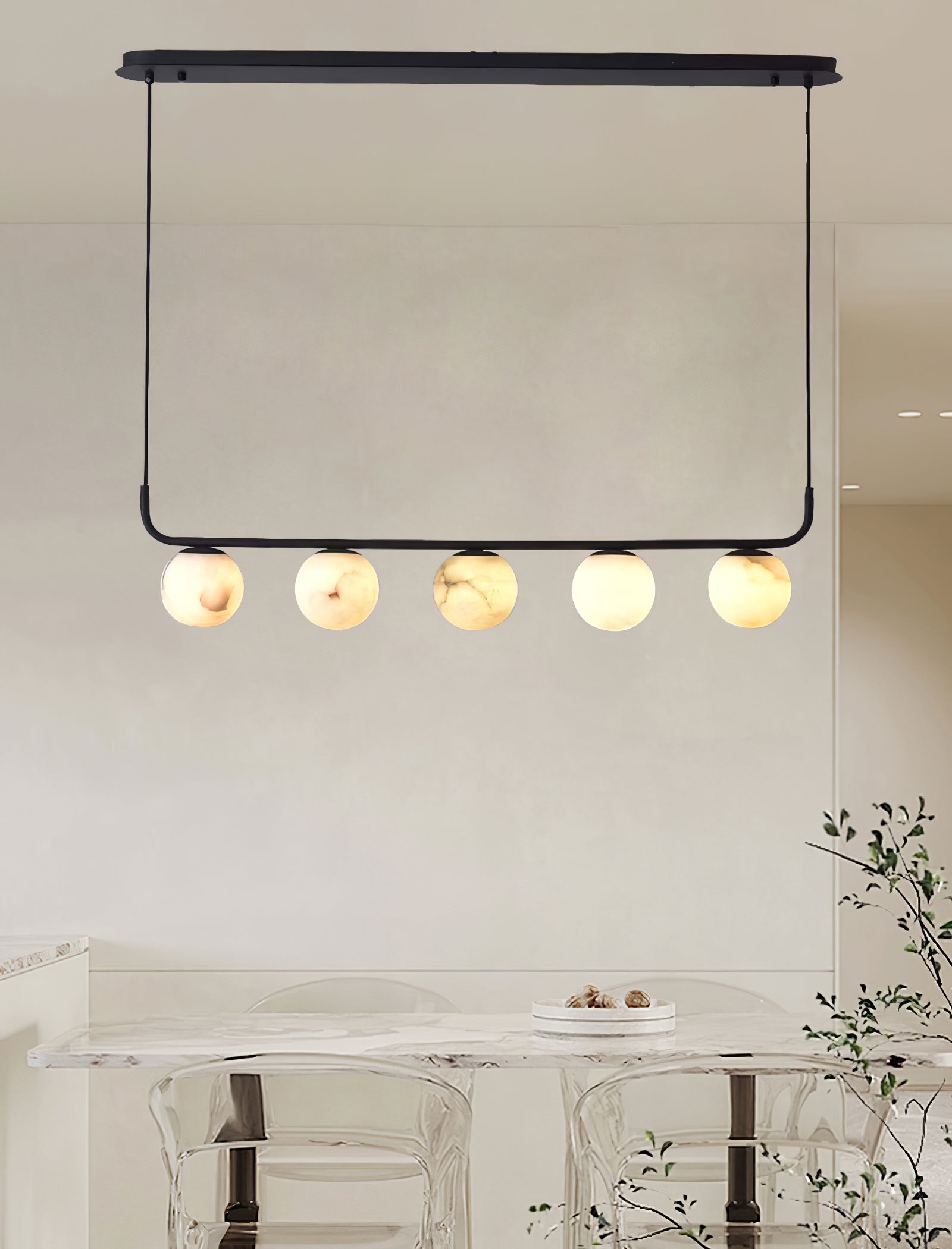 The Clérachic pendant hung from its oval ceiling plate in a bright room, five globes over a marble table.