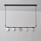 The Clérachic five-globe bar straight on and unlit, cool white stone with soft grey-brown veins against a grey wall.