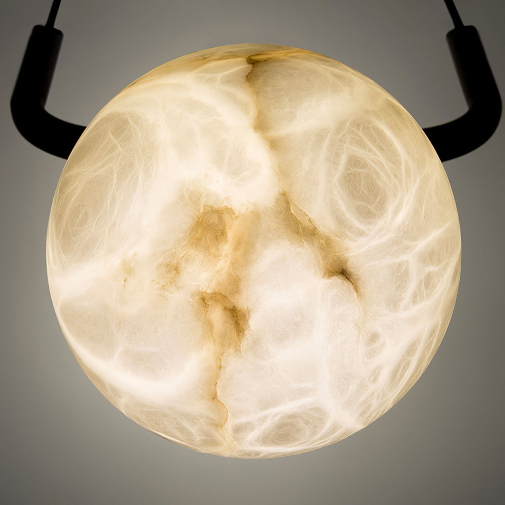 Macro of a single lit Clérachic globe, quarried alabaster turning honey-cream with amber veins running right through.