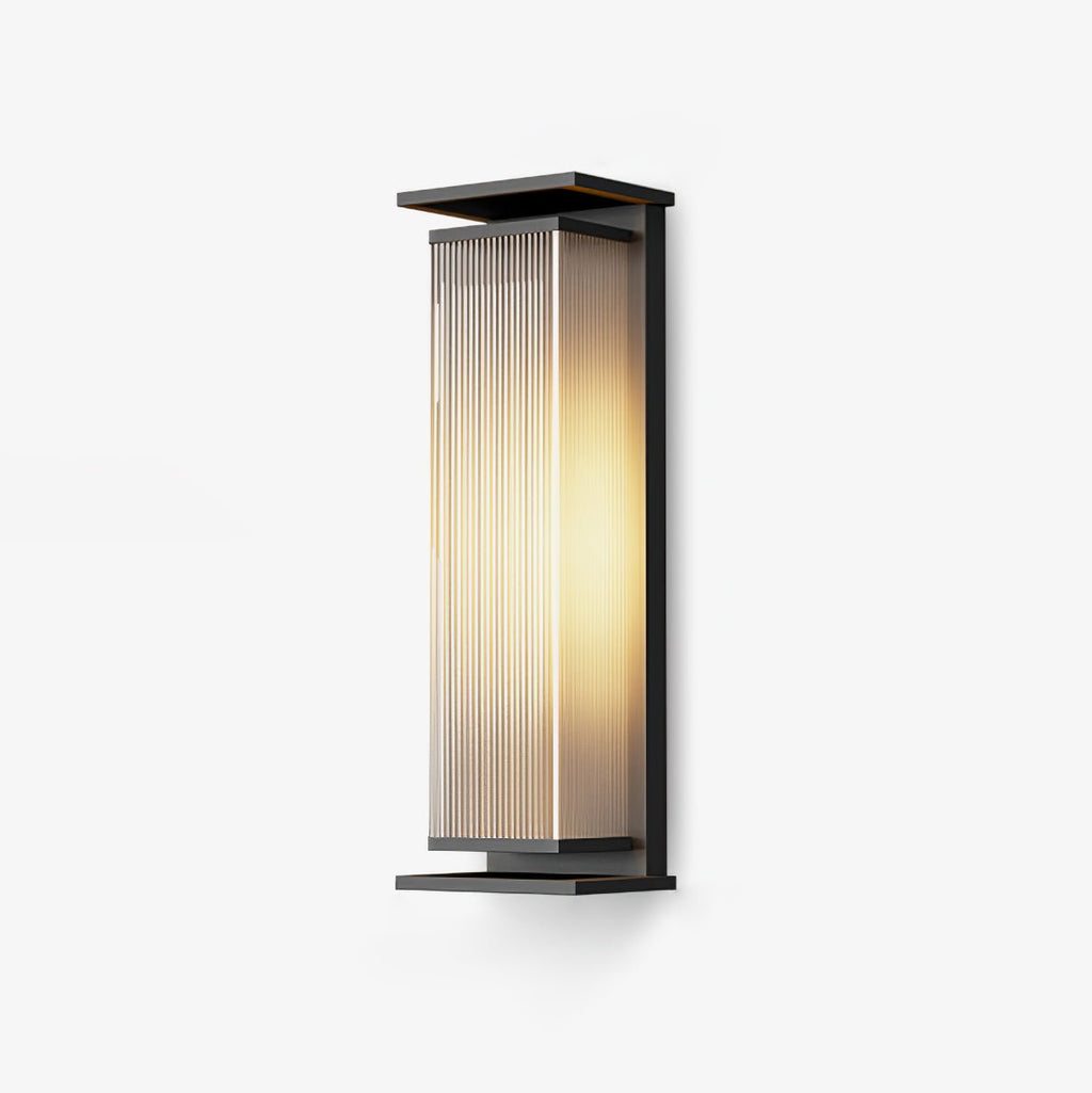 This Clérachic outdoor wall light on a plain white backdrop, with a black frame around a ribbed glass shade glowing warm.