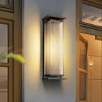 A Clérachic wall light centred between two glazed doors, its ribbed shade glowing warm in a black frame.