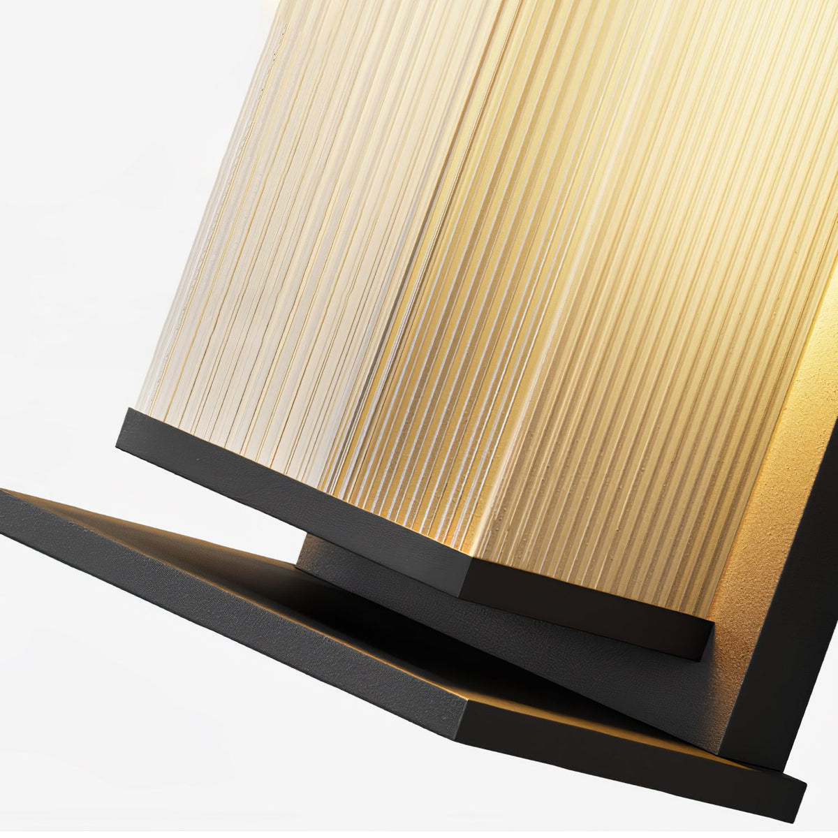 Close view of the ribbed glass shade and the black base plate of this Clérachic wall light, lit warm from within.