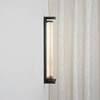 Side view of this Clérachic wall light, showing how far the black frame and ribbed shade stand out from the wall.