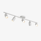 A white Clérachic ceiling track light with five adjustable spotlight heads on a slim bar, lit, on a plain white backdrop.
