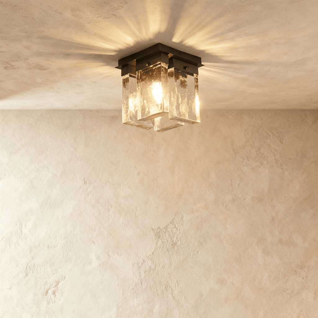 Clérachic flush ceiling light with four bubbled glass panels under a black mount, glowing and casting rays across a plaster ceiling.