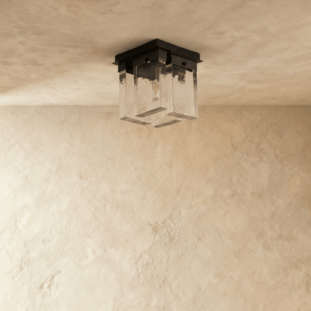 Clérachic ceiling light switched off: four rectangular textured glass panels beneath a square black metal mount on pale plaster.