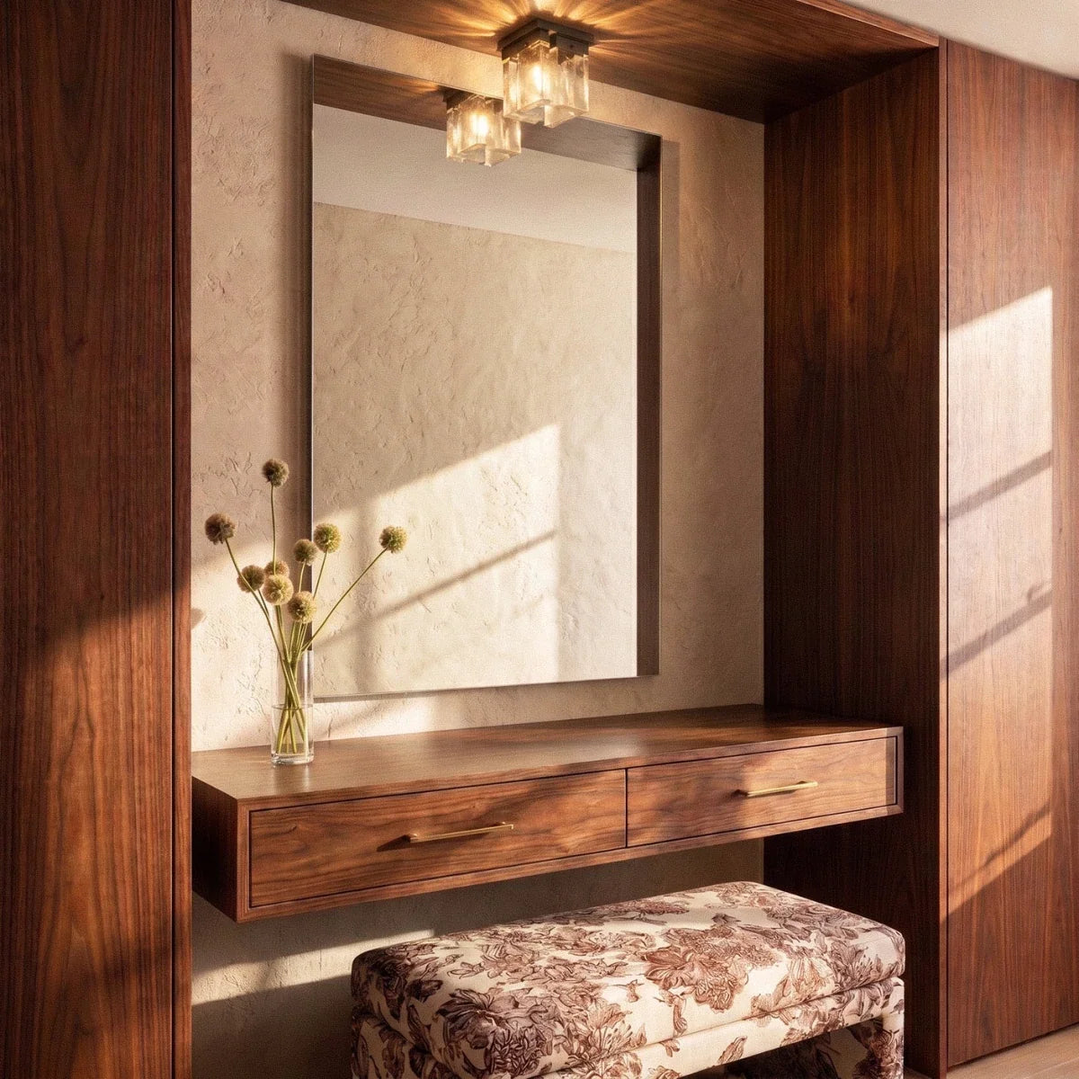 Clérachic bubbled glass ceiling light and its mirror reflection above a walnut dressing nook with drawers and a floral stool.