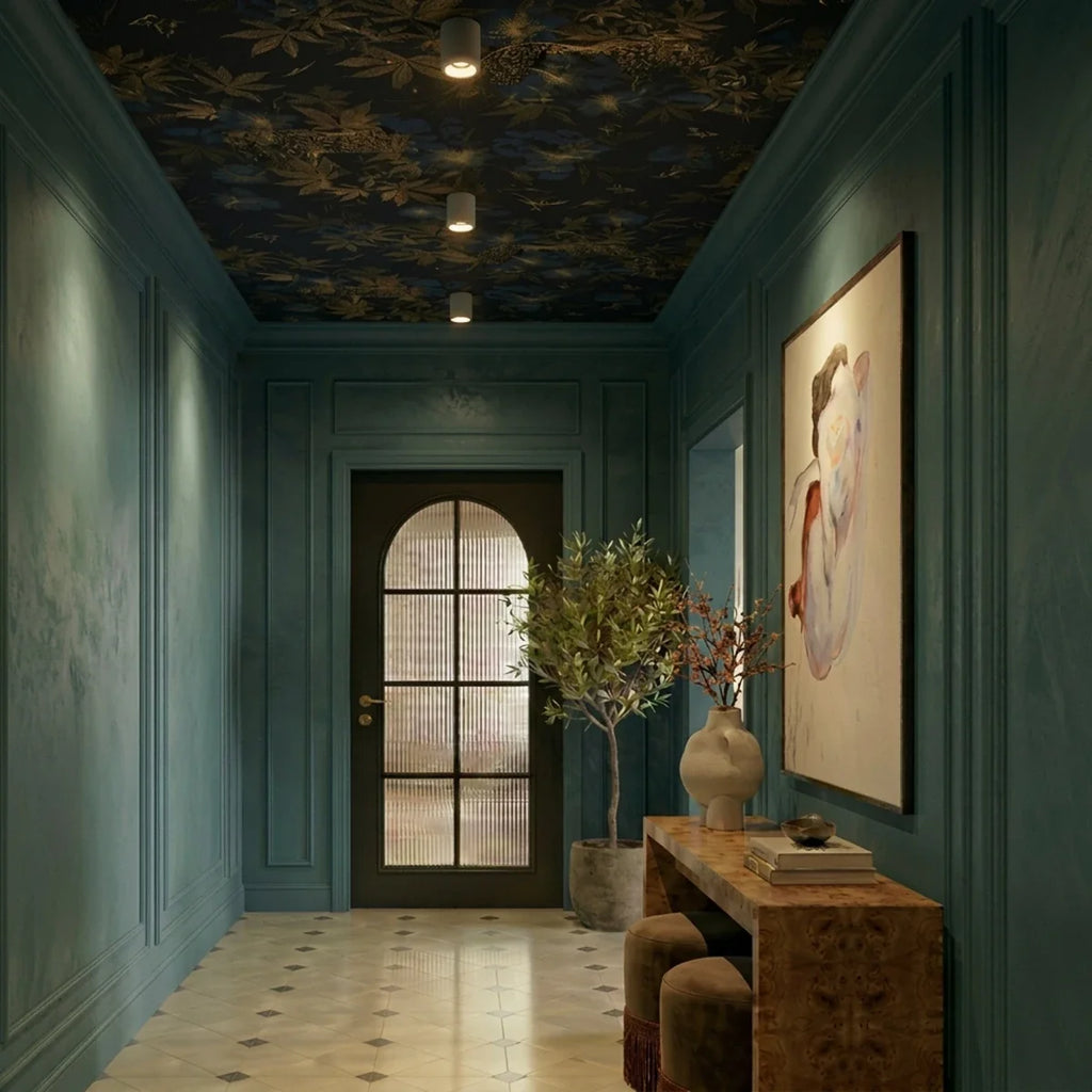 Clérachic downlights in white line a dark teal hallway ceiling patterned with a gold floral print.