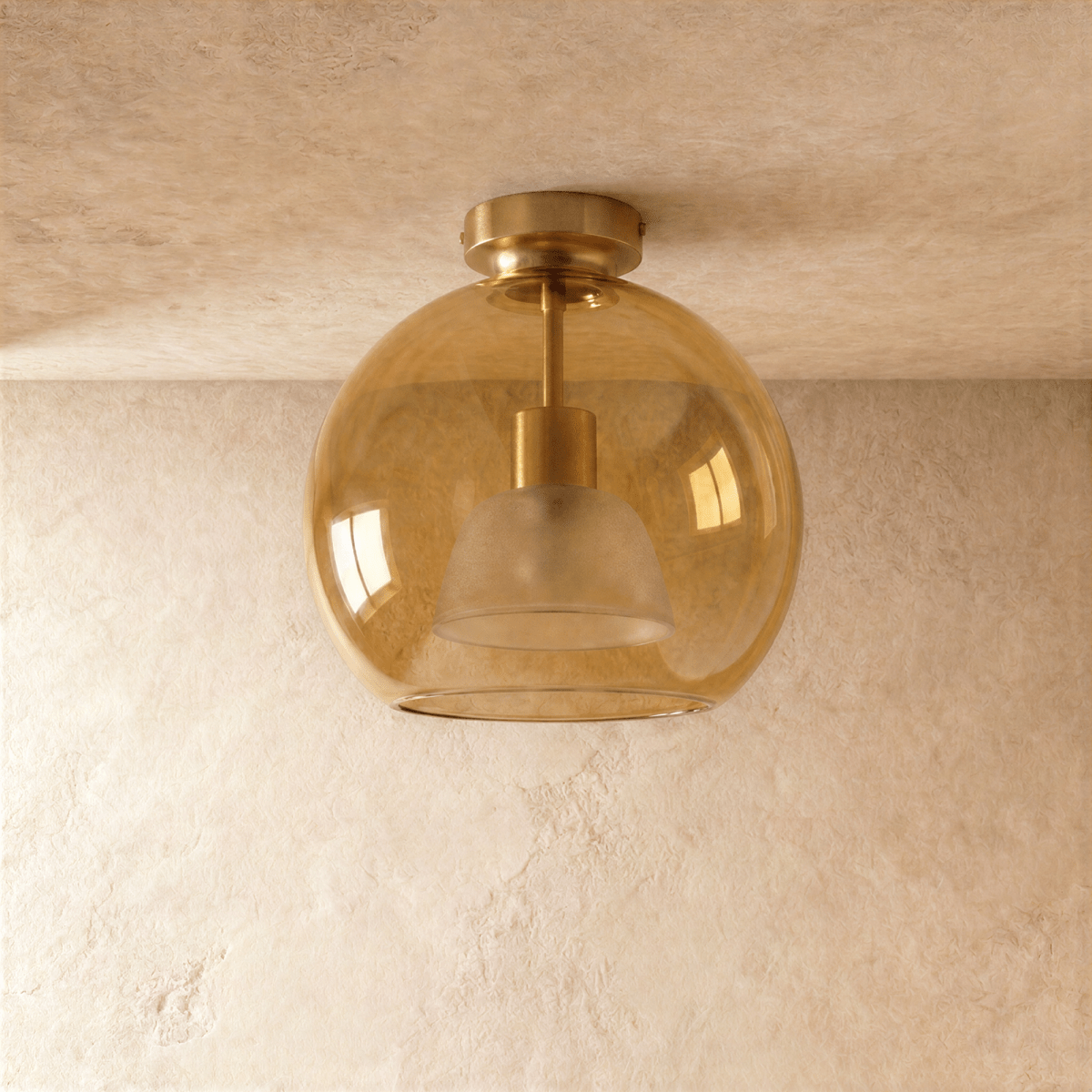 Clérachic wide amber glass globe ceiling light glows warm, its inner dome shade visible through the glass.