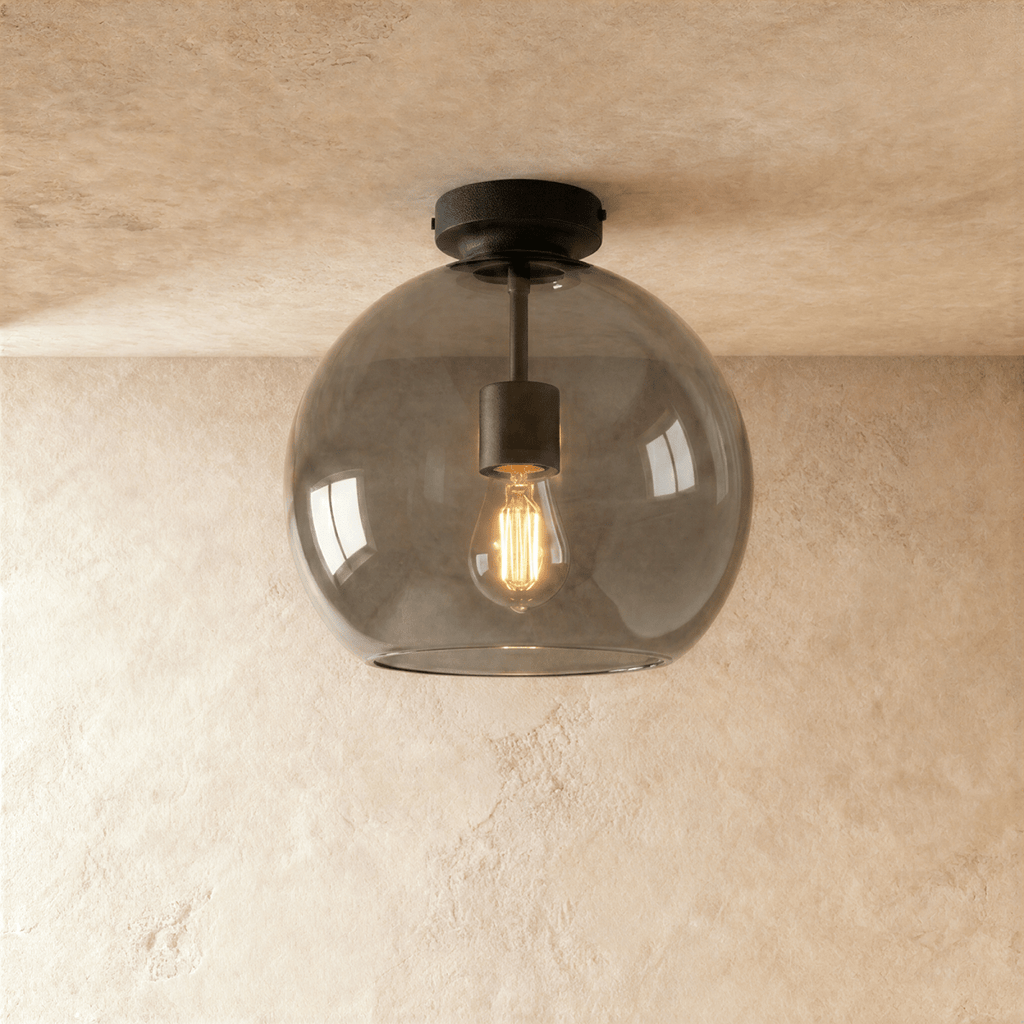 Clérachic smoked glass globe ceiling light flush-mounts with black hardware, filament bulb glowing inside.