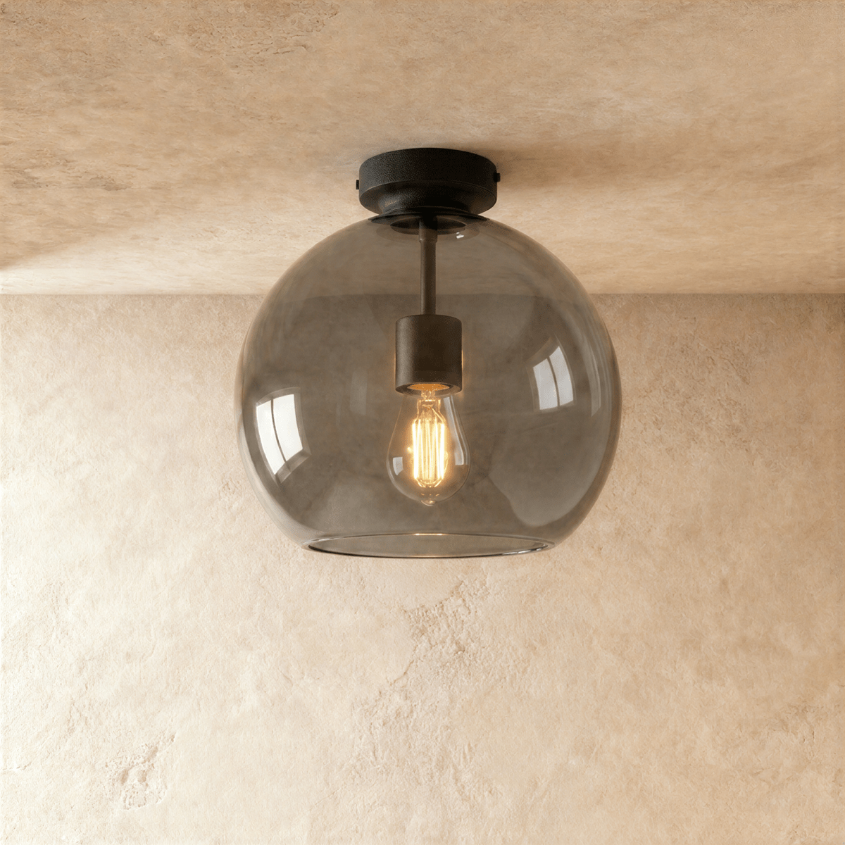 Clérachic smoked glass globe ceiling light flush-mounts with black hardware, filament bulb glowing inside.