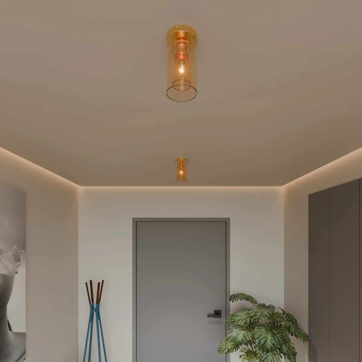 Clérachic amber glass cylinder ceiling lights, one pendant and one flush-mount, warm a hallway in gold.