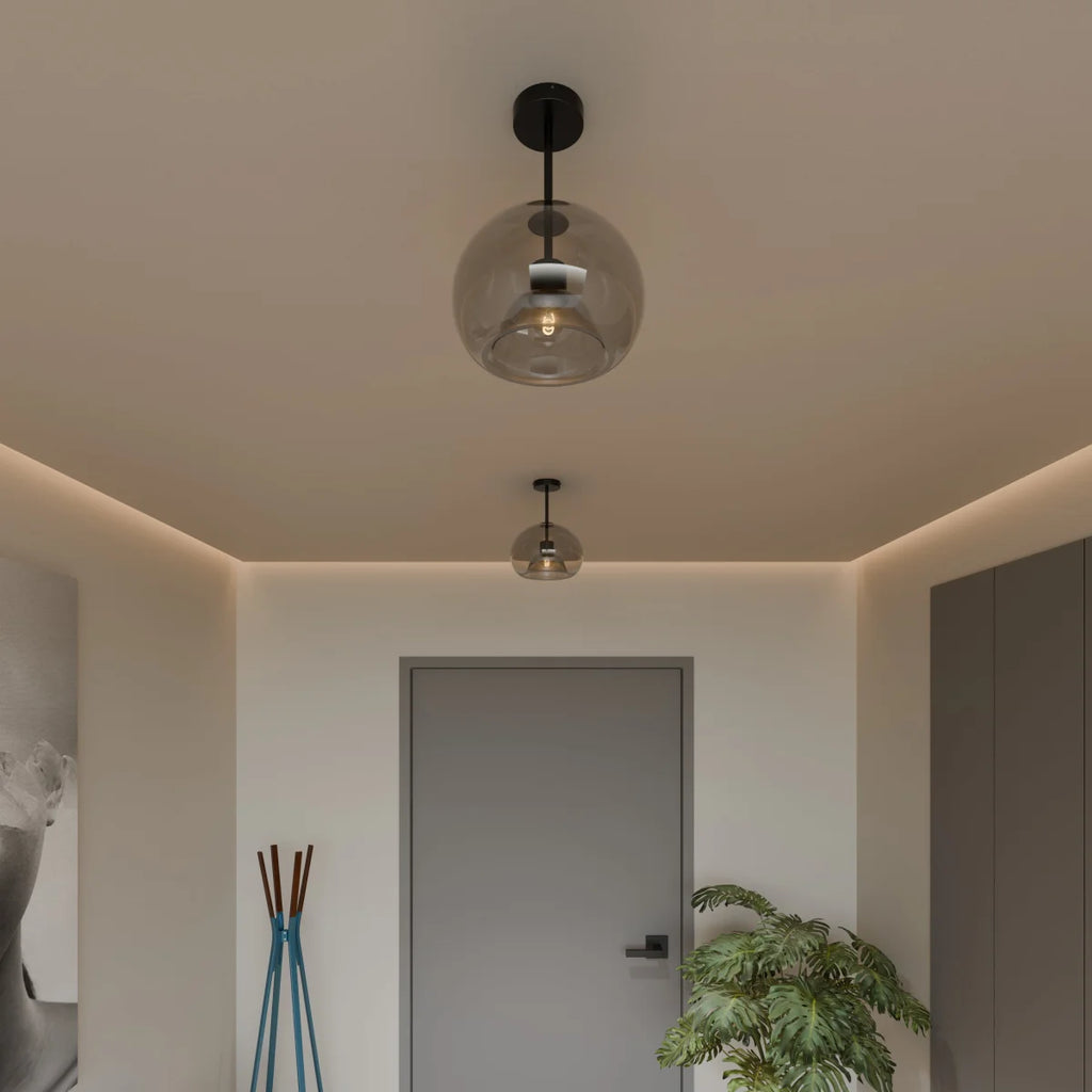 Clérachic smoked glass globe pendant and flush-mount ceiling lights, black hardware, in a modern hallway.