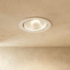 Clérachic downlight in white, the tiltable round trim glowing warm white against a plaster ceiling.