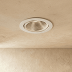 Clérachic downlight in white, the round tiltable trim glowing warm white from a different angle overhead.
