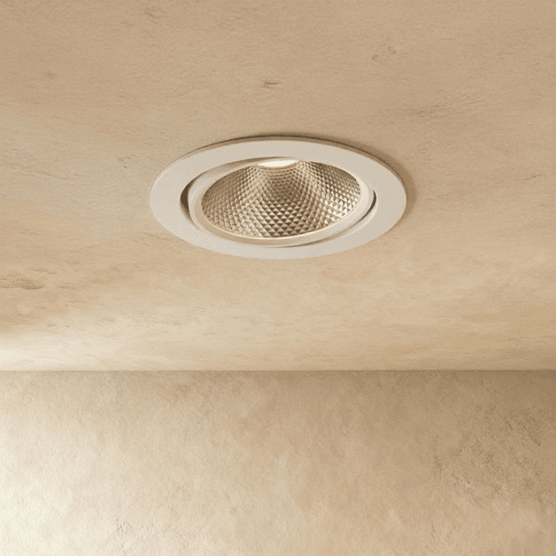 Clérachic downlight in white, the round tiltable trim glowing warm white from a different angle overhead.