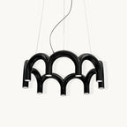 A black Clérachic chandelier made of two tiers of tubular arches, with downward-facing lights, on a plain white backdrop.