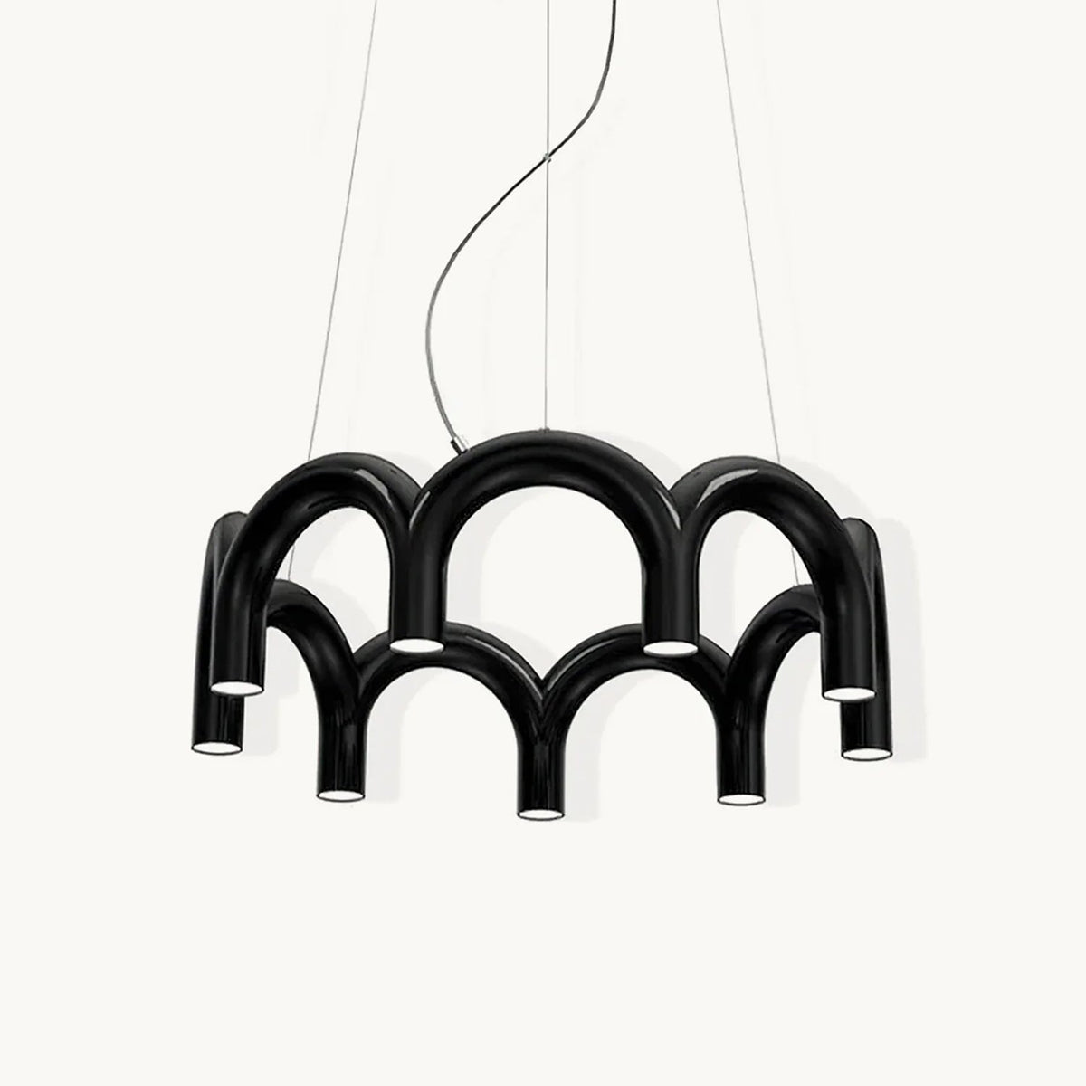 A black Clérachic chandelier made of two tiers of tubular arches, with downward-facing lights, on a plain white backdrop.