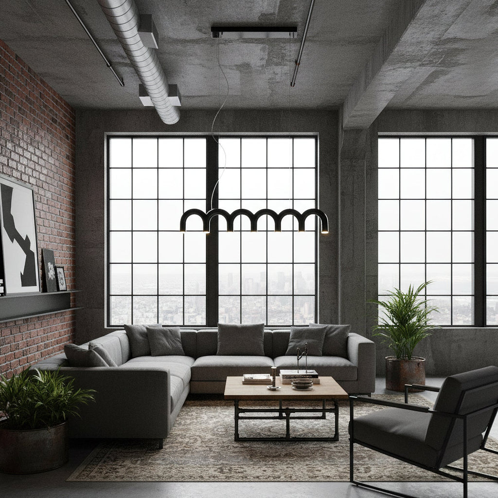 A row of black arches from this Clérachic chandelier hangs in front of tall steel windows, above a loft living room.