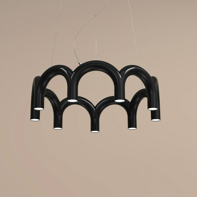 A black tiered-arch Clérachic chandelier on a warm sand-coloured backdrop, with its lights facing down.