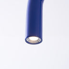 Close view of one blue tube end on this Clérachic chandelier, with a small downward-facing light inside it.