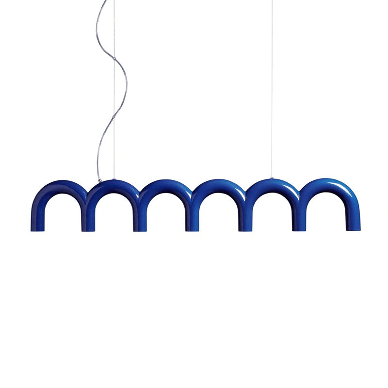 A blue arched Clérachic chandelier on two cables and a curved cord, on a plain white backdrop.