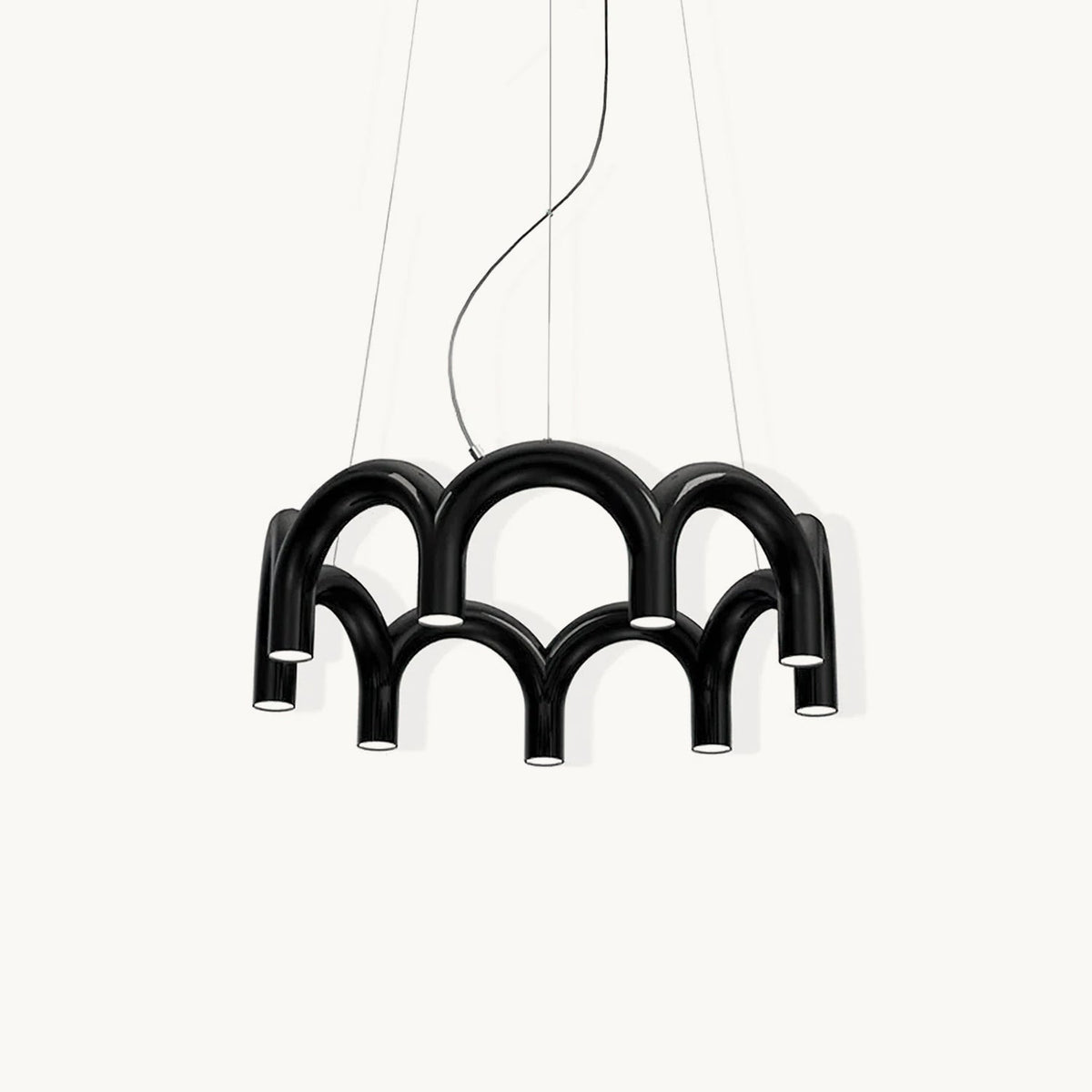 A black tiered-arch Clérachic chandelier on a soft off-white backdrop, hung on three cables.