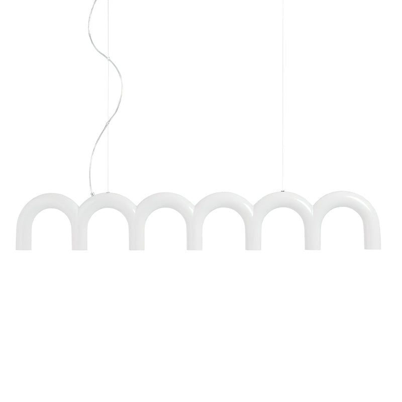 A white row of arches from this Clérachic chandelier, hung on a curved cord and a thin cable, on a white backdrop.