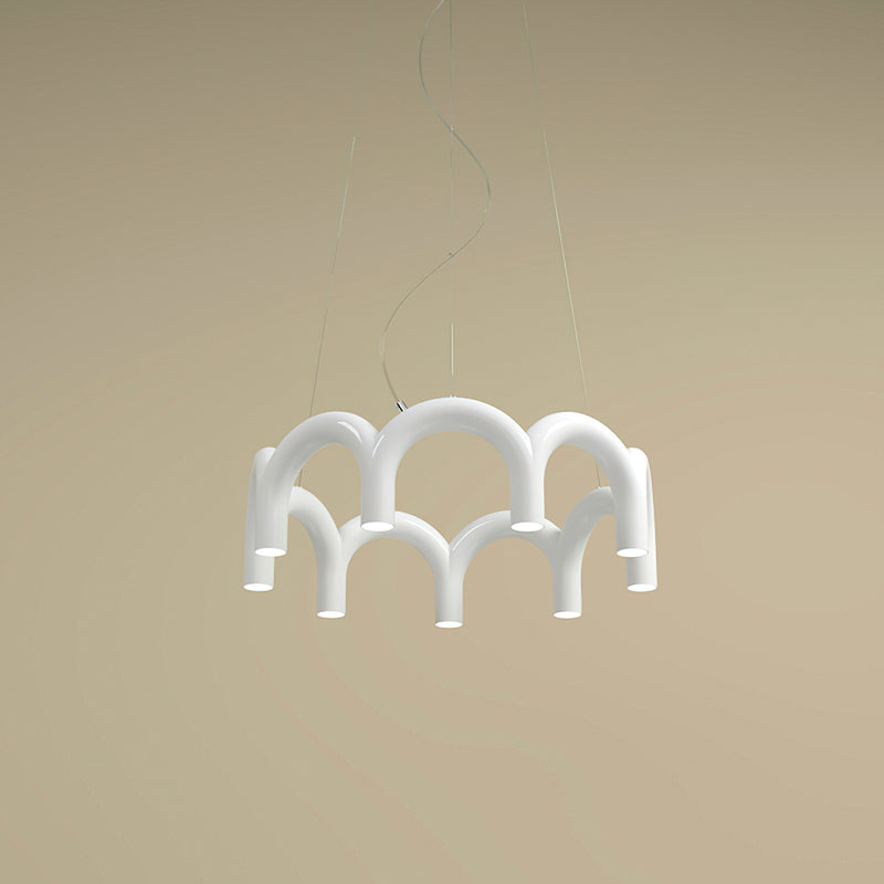 A small white tiered-arch Clérachic chandelier seen from below, against a sand-coloured backdrop.