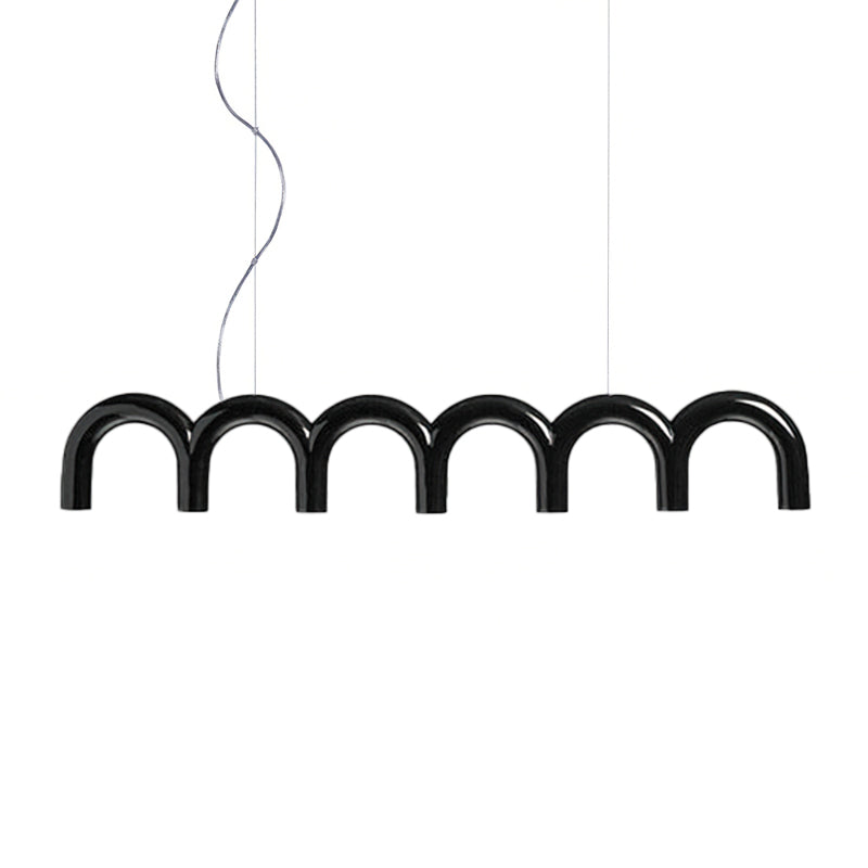 A black arched Clérachic chandelier with a glossy finish, hung on a curved cord and a thin cable, on white.