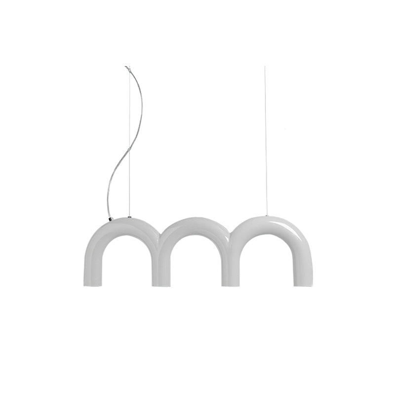 A short white Clérachic chandelier made of three arches, hung on a curved cord and a thin cable, on white.
