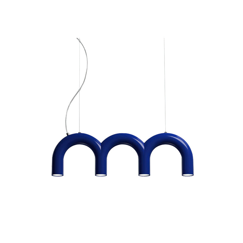 A short blue Clérachic chandelier made of three arches, with lights in each leg, on a plain white backdrop.