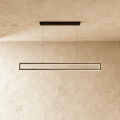 Clérachic black rectangular-frame pendant light, its slim LED edges glowing warm white beneath a plastered ceiling.