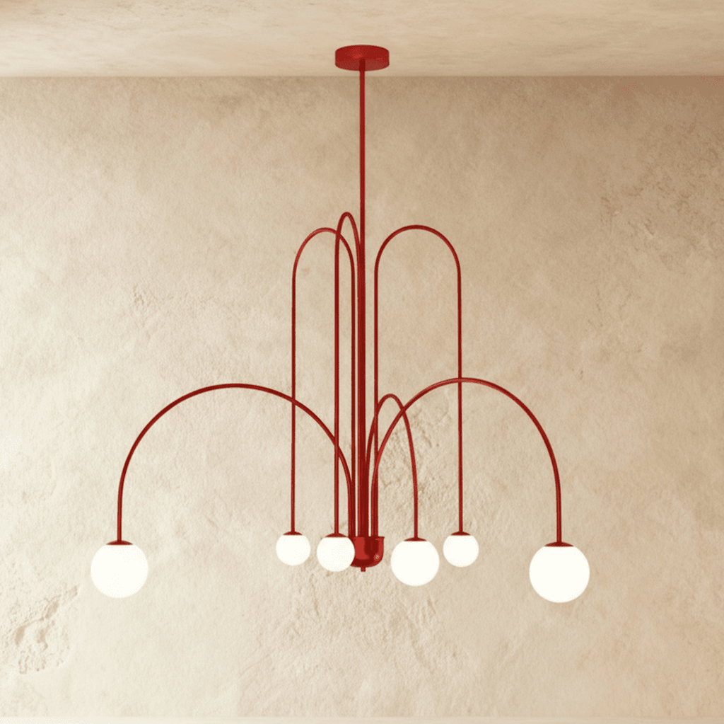 This Clérachic red Art Deco chandelier spans wide with looped arms and six round glass globe shades.