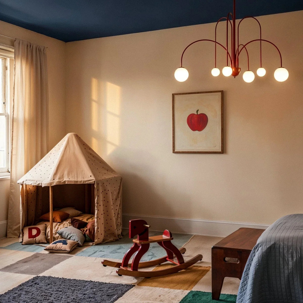 A Clérachic red Art Deco chandelier lights a child's bedroom with a play tent and a framed apple painting.