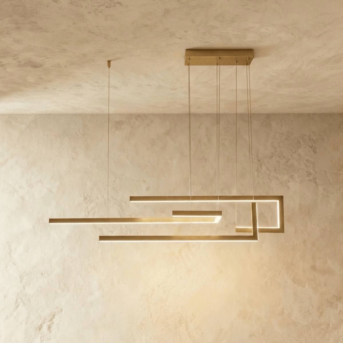 Clérachic's chandelier in gold, its interlocking linear bars forming a geometric maze suspended overhead.