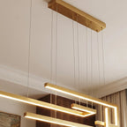 A close detail of the Clérachic chandelier in gold, showing its ceiling canopy and suspension cables.