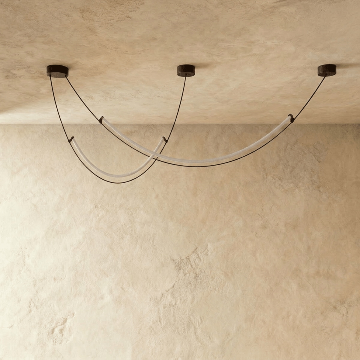 Clérachic chandelier of slim curved LED arcs switched off, showing the frosted tubes and black cables in a studio