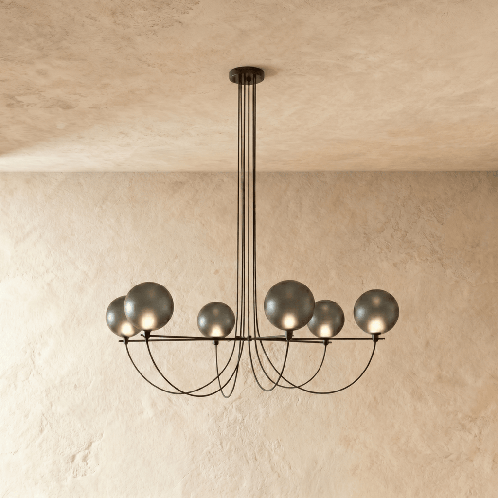 Clérachic six-globe chandelier with smoky grey glass shades on a black iron armature, lit, hung from slim black cords.