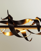 Clérachic detail of brushed black steel ribbons with gold-toned insides, wrapped around a glowing horizontal LED bar.