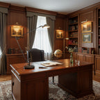 A Clérachic black arm lamp on a polished wooden desk in a panelled study, with framed landscapes and bookshelves behind.