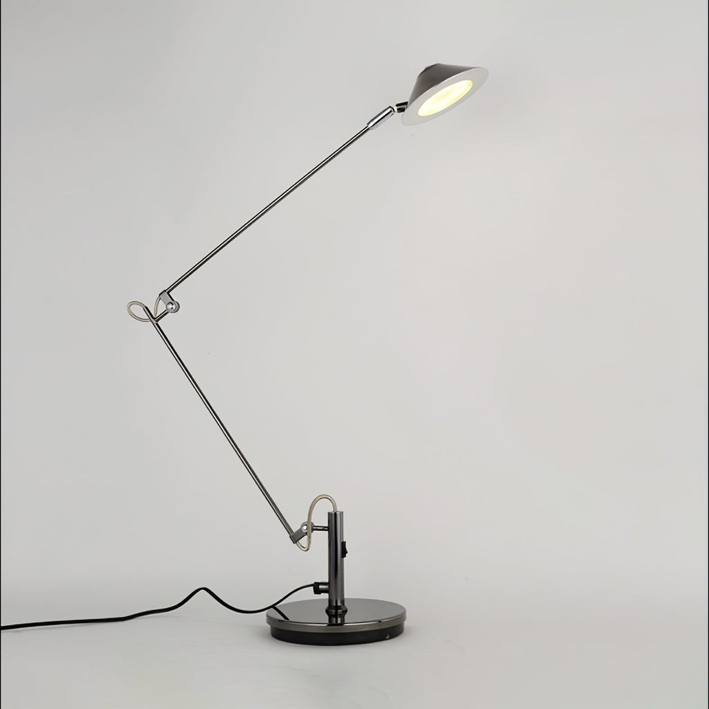 A Clérachic black adjustable lamp with its jointed arm folded and the lit shade tilted up on the right, on grey.