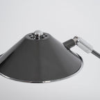 Close view of the top of this Clérachic lamp shade, with a small chrome cap, vent holes and the chrome hinge at the arm.