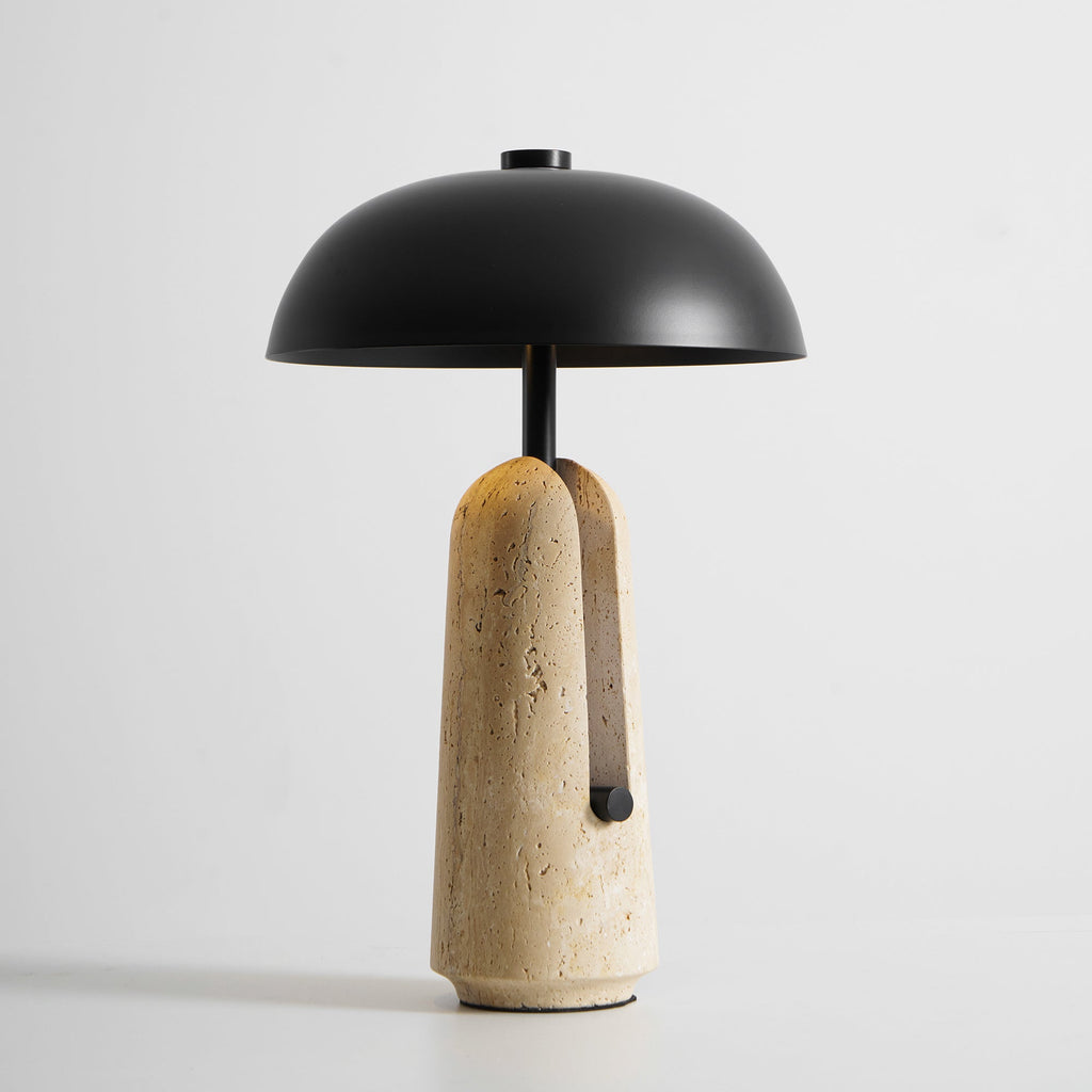 Slightly lower angle of this Clérachic table lamp, the black dome shade wider than its narrow travertine base.