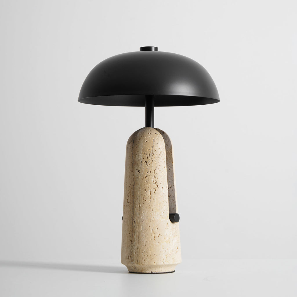 Slightly raised angle showing the inside of the black dome shade on this Clérachic table lamp above its travertine base.