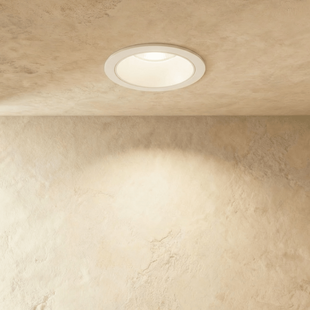 Straight-on view of the Clérachic white recessed downlight, its round trim glowing warm white overhead.