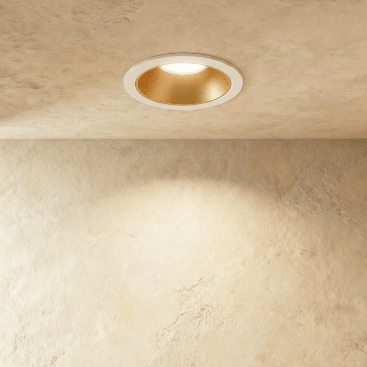 The Clérachic recessed downlight in white and gold, its gold baffle glowing warm white within a white trim ring.