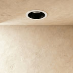 Another angle of the Clérachic black and white recessed downlight, its baffle glowing white against a plaster ceiling.