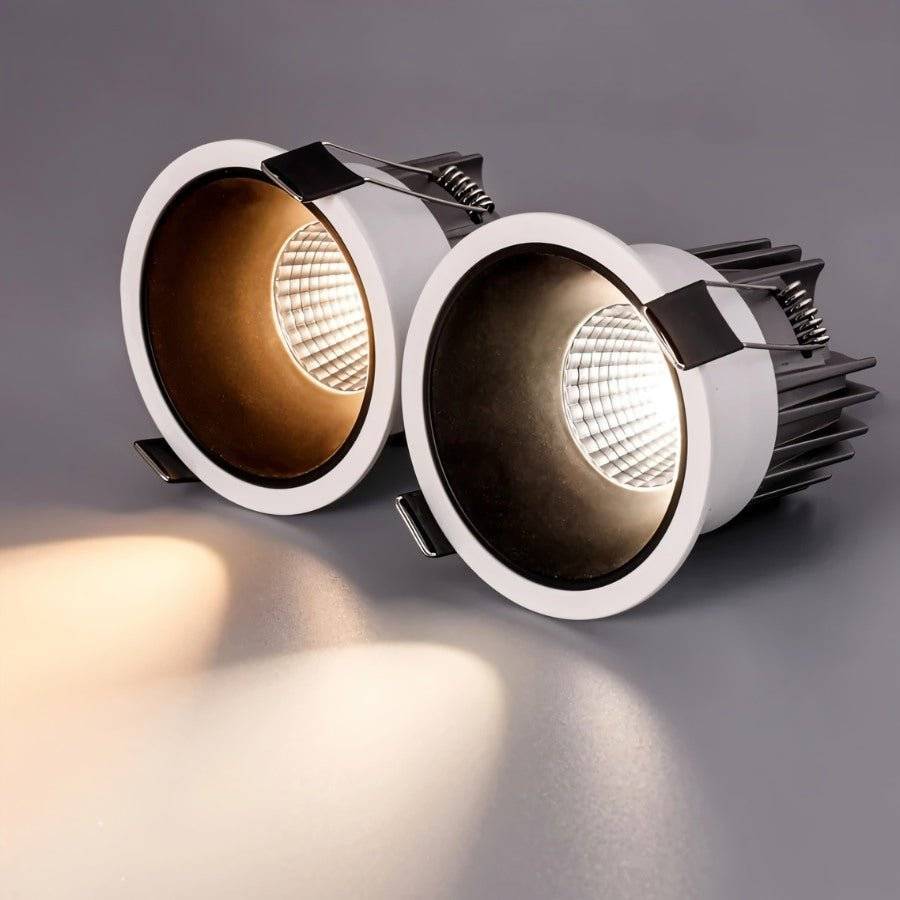 Two Clérachic recessed downlights compared side by side, one glowing warm white and one glowing cooler white.