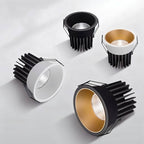 Four Clérachic recessed downlight modules in black, white and gold finishes, shown with their exposed heat-sink bodies.